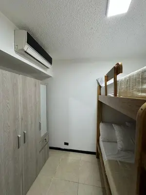 a room with a bunk bed and a closet at Apartasol Ciudadela SantaFe de Antioquia in Santa Fe de Antioquia