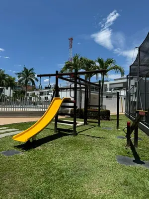 a playground with a yellow slide in a park at Apartasol Ciudadela SantaFe de Antioquia in Santa Fe de Antioquia