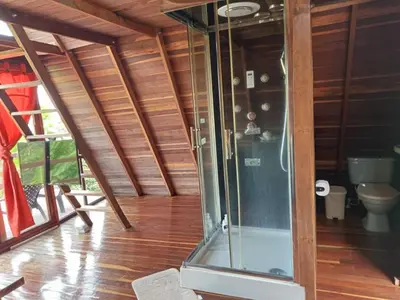 a glass shower in a room with a toilet at Cabaña en Jericó in Jericó