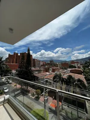 a view of a city from a balcony at Apartamento en Laureles, con piscina y parquedero 401 in Medellín