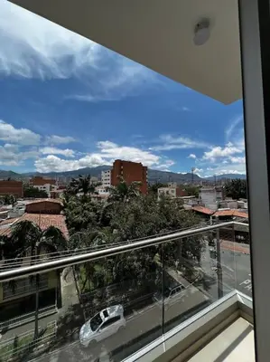 a view of a city from a glass window at Apartamento en Laureles, con piscina y parquedero 401 in Medellín