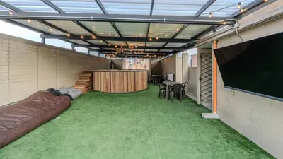 a conference room with a large screen and green carpet at Apartamento en laureles con piscina y parqueadero 402 in Medellín