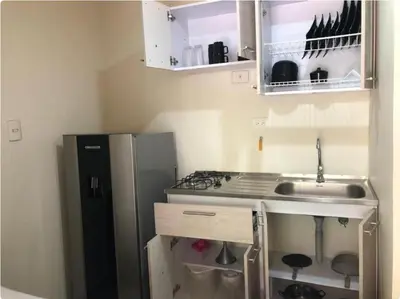 a small kitchen with a sink and a refrigerator at Apartaestudios contiguos cerca al Centro Comercial Fabricato in Bello