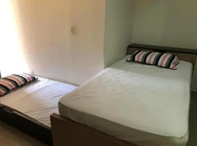 a bedroom with a bed with two pillows on it at Apartaestudios contiguos cerca al Centro Comercial Fabricato in Bello