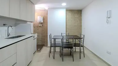 a kitchen with a table and chairs in it at Apartamento en laureles con piscina, parqueadero 302 in Medellín