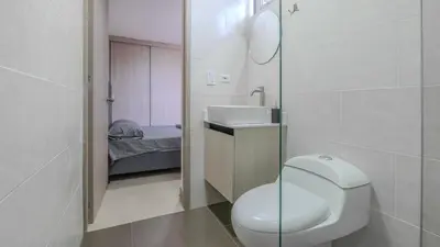 a small bathroom with a toilet and a sink at Apartamento 2BR Parqueadero y Piscina 202 in Medellín