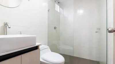 a bathroom with a toilet and a sink and a shower at Apartamento 2BR Parqueadero y Piscina 202 in Medellín