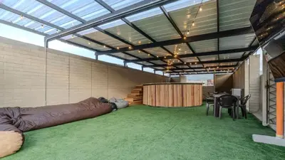 a large room with a large couch and a table and chairs at Apartamento 2BR Parqueadero y Piscina 202 in Medellín