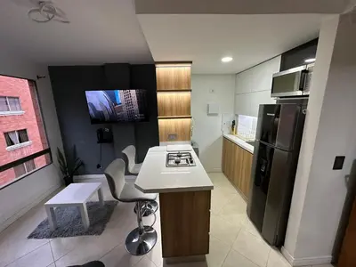 a small kitchen with a stove and a refrigerator at Apartaloft in Sabaneta