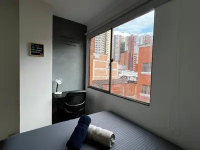 a room with a window with a towel on a bed at Apartaloft in Sabaneta