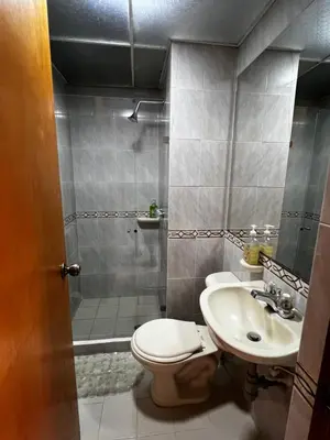 a bathroom with a toilet and a sink and a shower at Apartaloft in Sabaneta