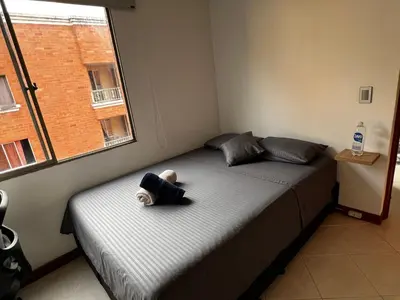 a teddy bear sitting on a bed in a bedroom at Apartaloft in Sabaneta