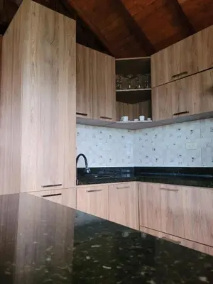 a kitchen with wooden cabinets and a sink at Pedacito de cielo in San Antonio de Prado
