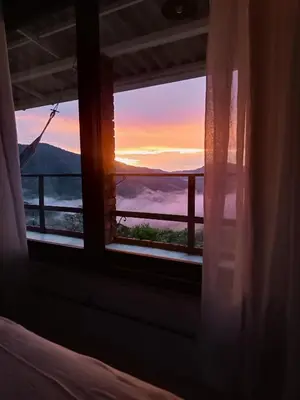 a room with a window with a view of the sunset at Bosque Místico in San Carlos