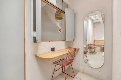 a room with a table and chairs and a mirror at Botánica Casa Hotel Manila by HOUSY in Medellín