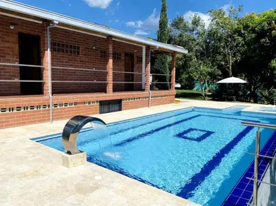 a swimming pool in front of a house at Finca con Piscina Privada in San Jerónimo
