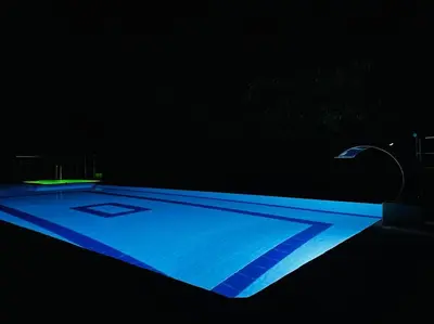 a swimming pool in the dark with a street light at Finca con Piscina Privada in San Jerónimo