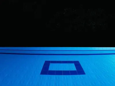 an empty swimming pool with a blue tile floor at Finca con Piscina Privada in San Jerónimo