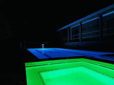 a swimming pool with blue and green lights at Finca con Piscina Privada in San Jerónimo