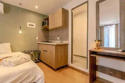 a room with a bed and a sink and a bathroom at Loft Recuerdos de mi tierra in Medellín
