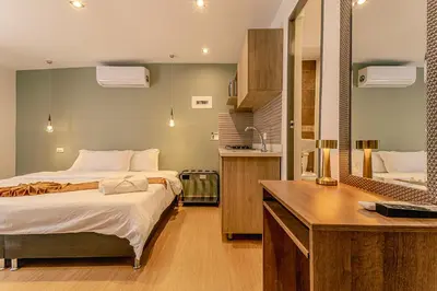 a bedroom with a bed and a desk and a mirror at Loft Recuerdos de mi tierra in Medellín