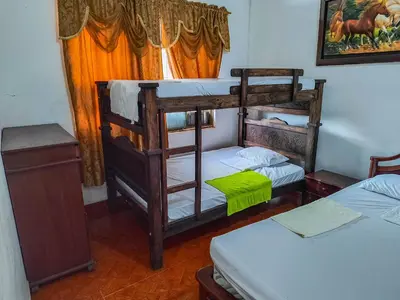 a room with two bunk beds and a window at Casa de Veraneo in Mariquita