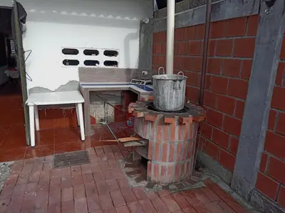 a brick oven with a bucket on top of it at Casa de Veraneo in Mariquita