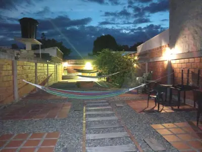 a hammock on a patio at night at Casa de Veraneo in Mariquita