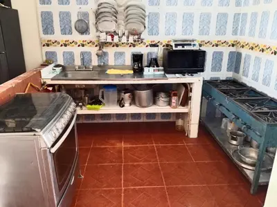 a small kitchen with a sink and a stove at Casa de Veraneo in Mariquita