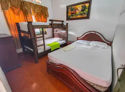 a bedroom with two bunk beds and a window at Casa de Veraneo in Mariquita