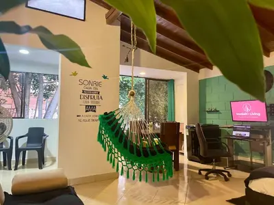an office with a desk and chairs and a sign at explora la magia de laureles in Medellín