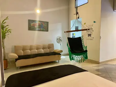 a living room with a couch and a chair at explora la magia de laureles in Medellín