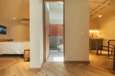 a room with a bedroom with a bed and a bathroom at Hotel Boutique Roomzz Laureles in Medellín