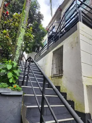 a set of stairs next to a building with a window at Acogedor apartaloft El Poblado in Medellín