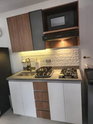 a kitchen with a sink and a microwave at Acogedor apartaloft El Poblado in Medellín