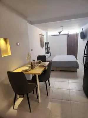 a room with a table and chairs and a bed at Acogedor apartaloft El Poblado in Medellín