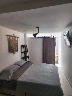 a bedroom with a bed and a ladder and a shelf at Acogedor apartaloft El Poblado in Medellín