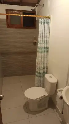 a bathroom with a toilet and a shower at Finca Hotel La Estancia Santa Fe in Santa Fe de Antioquia