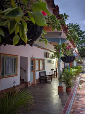 a porch of a house with potted plants at Hotel Bosque Blue in San Jerónimo