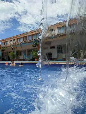 a water fountain in a swimming pool at Hotel Bosque Blue in San Jerónimo