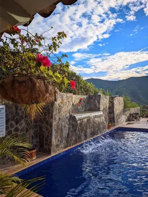a swimming pool with a view of the mountains at Hotel Bosque Blue in San Jerónimo
