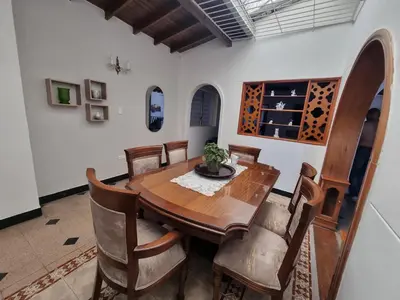 a dining room with a wooden table and chairs at Amplia y Cómoda casa en la 70 in Medellín