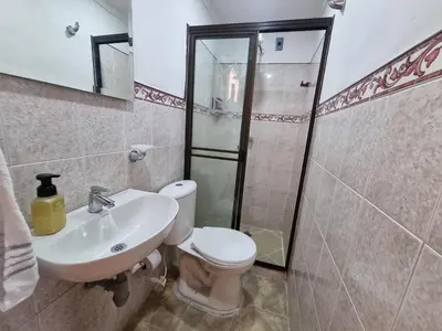a bathroom with a toilet and a sink and a shower at Amplia y Cómoda casa en la 70 in Medellín
