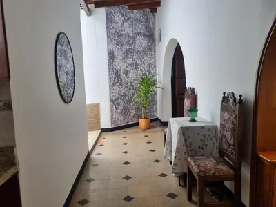 a hallway with a table and a table and chairs at Amplia y Cómoda casa en la 70 in Medellín