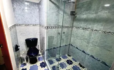 a bathroom with a glass shower with a toilet at Amplia y Cómoda casa en la 70 in Medellín