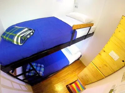 a room with two bunk beds in a room at Hostal de la 57 in Manizales
