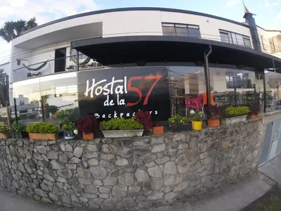 a sign on a wall in front of a building at Hostal de la 57 in Manizales