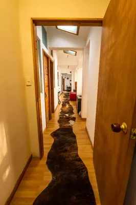 a long hallway with a long rug on the floor at Hostal de la 57 in Manizales