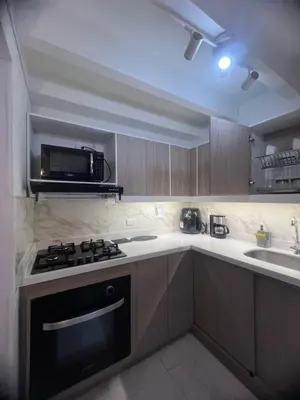 a kitchen with a stove and a microwave at Espectacular Casa Familiar in Belén