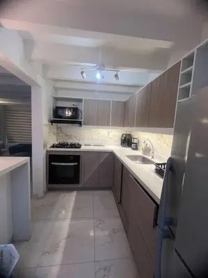 a kitchen with a sink and a stove top oven at Espectacular Casa Familiar in Belén